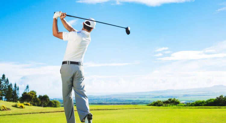 Golfer finishing his swing. A golfers swing can damage your medial epicondylitis